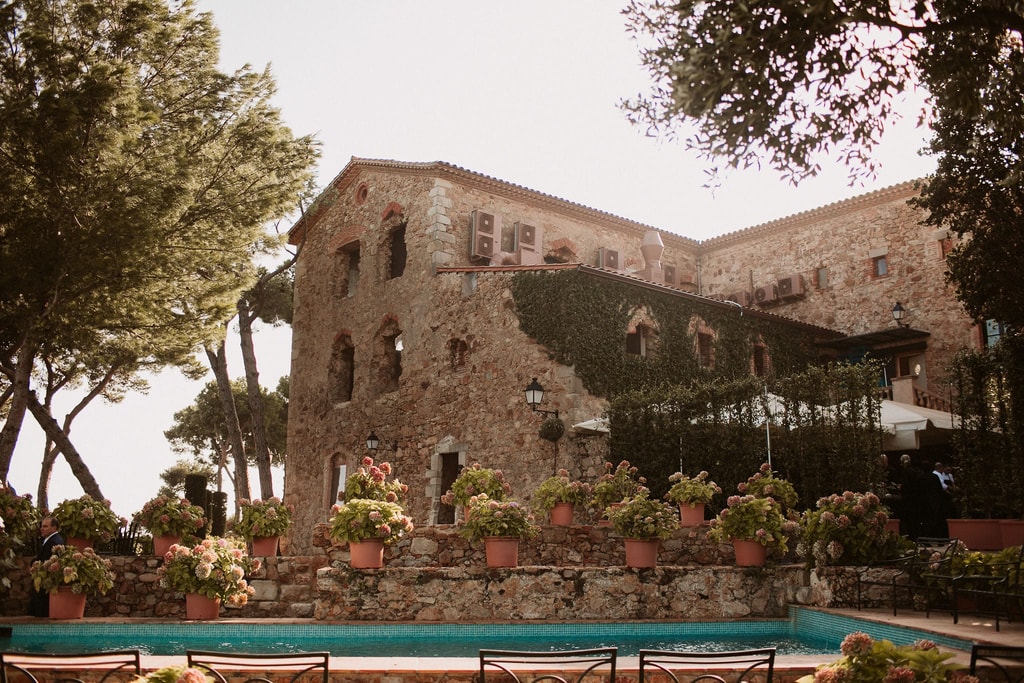 Stone building surrounded by lush greenery. Wedding locations in Costa Brava