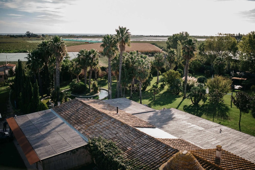 Aerial view of the gardens of Cortal Gran surrounded by apple fields