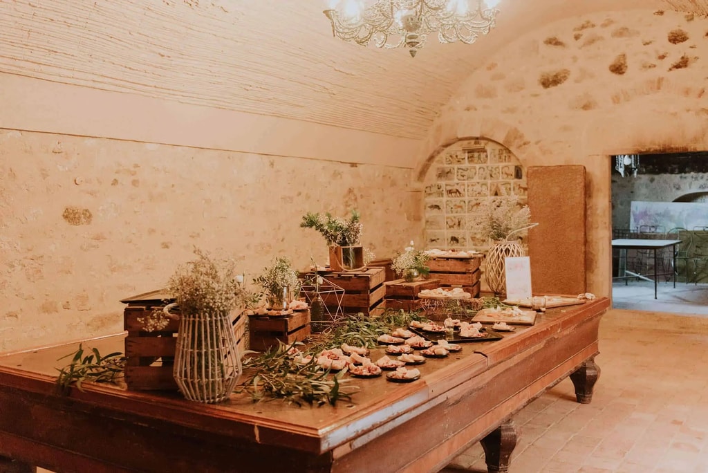 Vaulted stone hall at Cortal Gran set up for a wedding aperitif