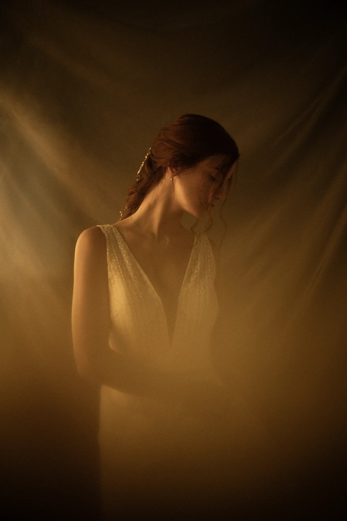Warm, moody portrait of a woman in soft golden light, fine art photography