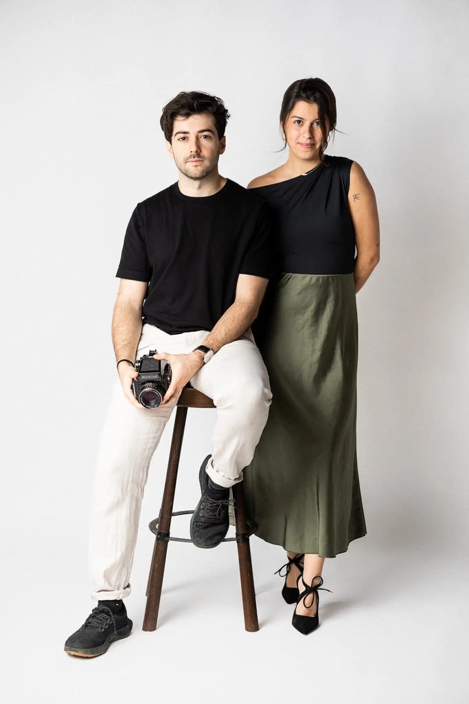 Wedding photographers of Timeless Wedding Studio posing together with a camera